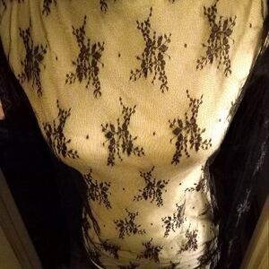 New with tag sheer mesh black lace long sleeve top with boat neck size medium.